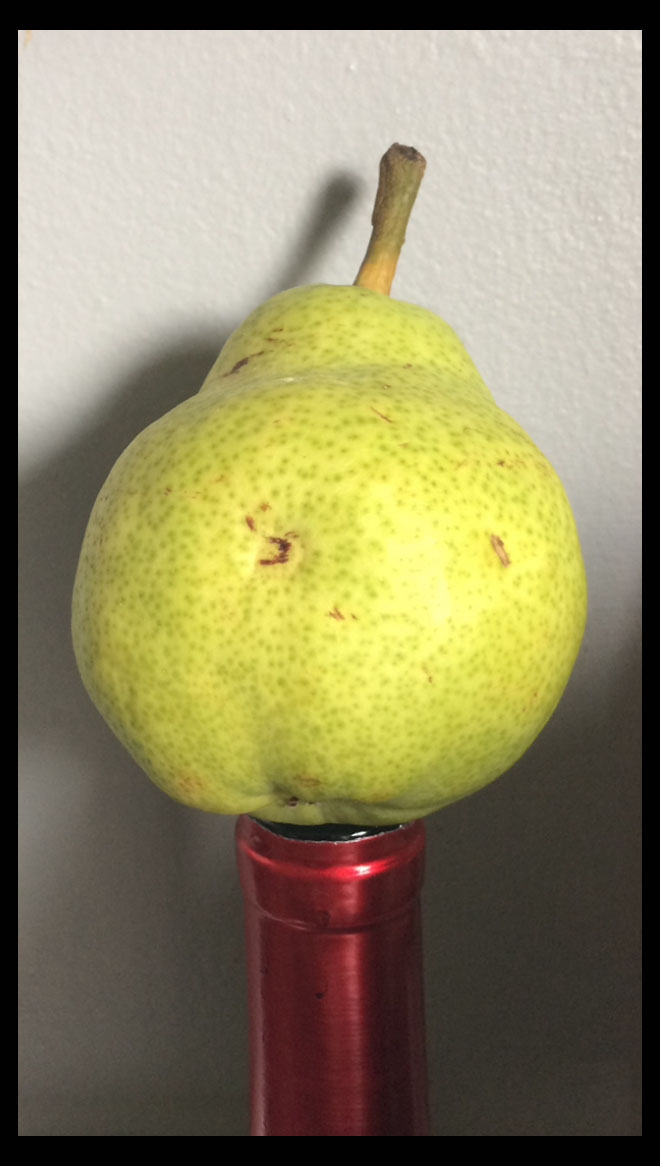 pear on wine bottle